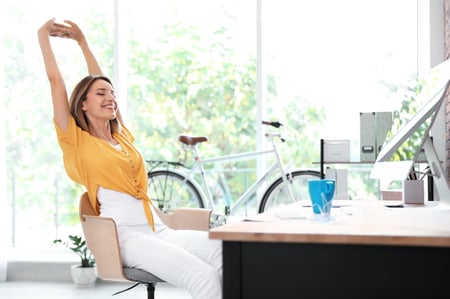 employee stretching at desk